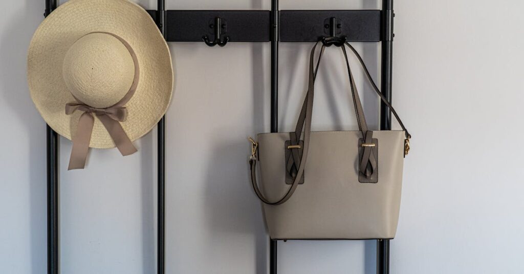 A stylish sun hat and leather handbag hanging on a modern wall hook indoors.